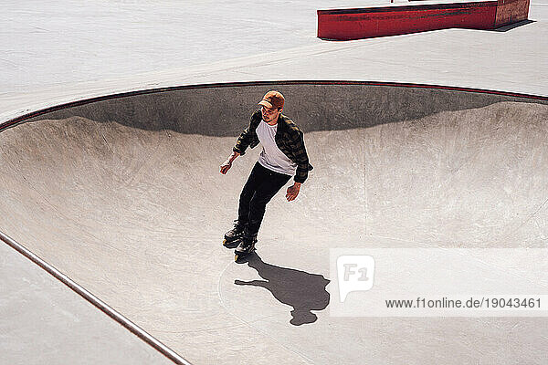 aggressive roller skater riding in skatepark