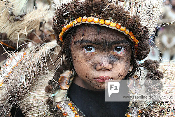 Little girl with black smeared faces wearing tribal costume at Ati Atihan festival  Kalibo  Aklan  Panay Island  Philippines