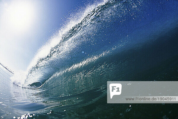 View from the water of a sun-spotted wave in Santa Cruz  California.