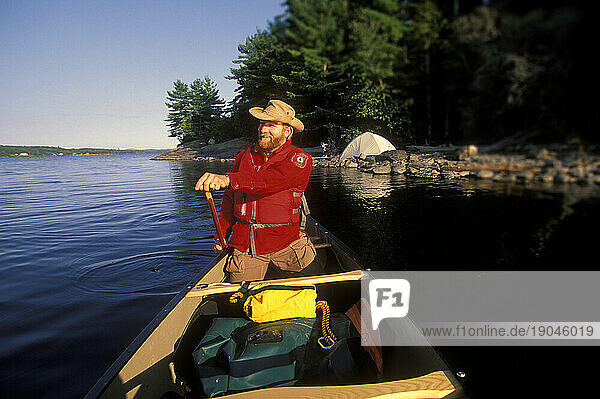 Registered Maine guide canoeing on Lobster Lake  Maine.