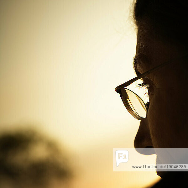 Profile of a woman wearing glasses.