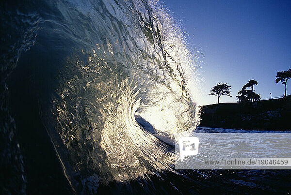 View of the inside of a crashing wave in the late afternoon in Santa Cruz  California.