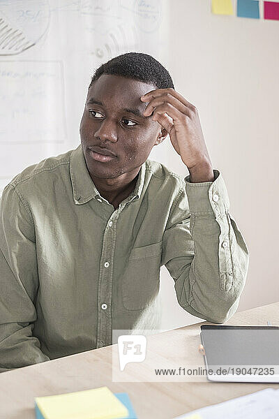 Black young man studying on a table