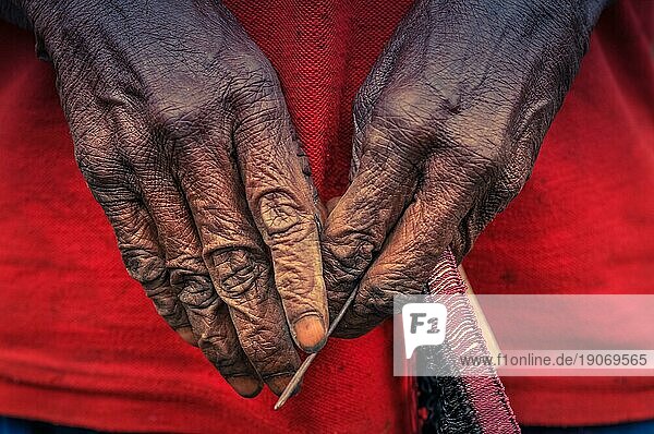 Foto der von Zeit und harter Arbeit gezeichneten Hände einer Frau im Dani Kreis bei Wamena  Papua  Indonesien. In dieser Region kann man nur Menschen aus isolierten lokalen Stämmen treffen