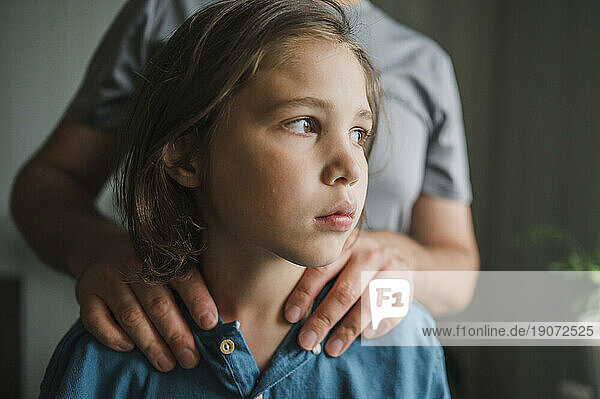 Thoughtful son with father at home