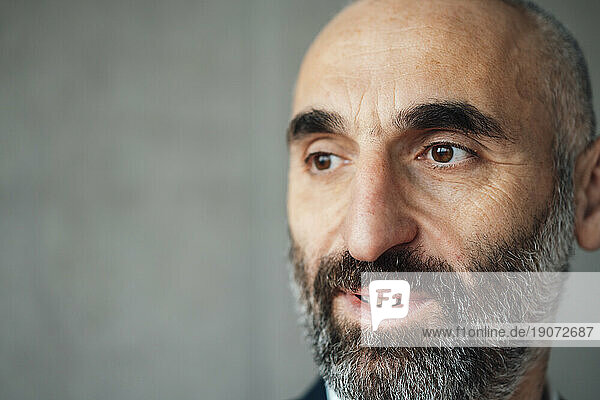 Thoughtful mature businessman with beard