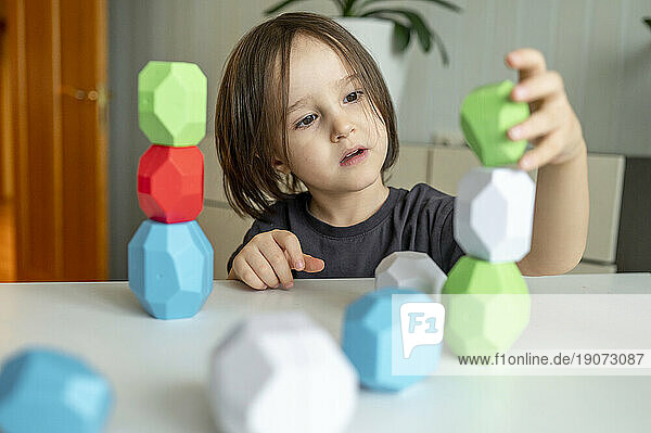 Boy playing with block towers at home