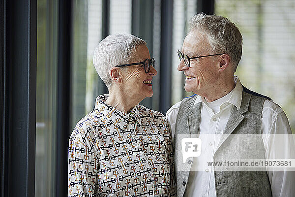 Happy senior couple looking at each other at home