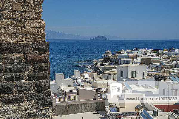 View of sea and whitewashed buildings and rooftops of Mandraki  Mandraki  Nisyros  Dodecanese  Greek Islands  Greece  Europe