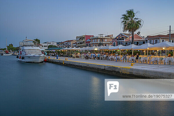 View of cafe and restaurant at the harbour at dusk,  Lixouri,  Kefalonia,  Ionian Islands,  Greek Islands,  Greece,  Europe