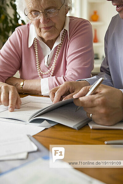 Portrait of a businessman and woman sitting and looking at documents
