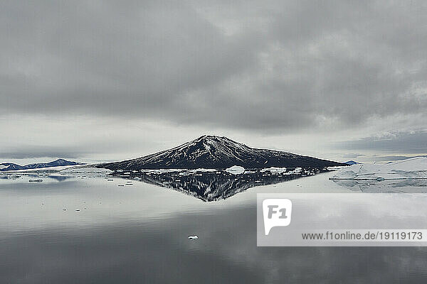 Clouds over majestic mountain and tranquil ocean  Antarctic Peninsula  Weddell Sea  Antarctica