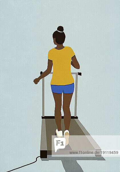 Woman exercising  walking on treadmill