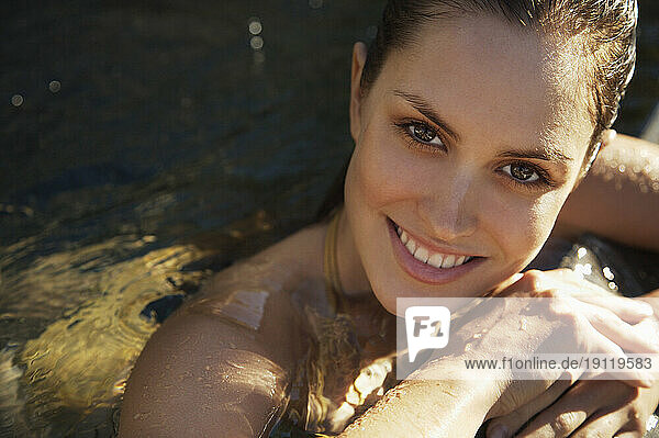 Woman in a swimming pool smiling