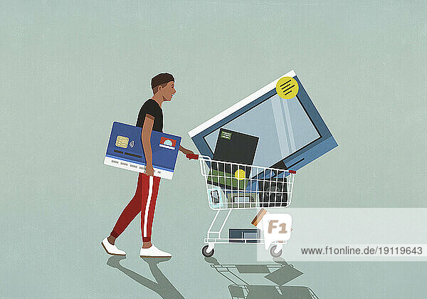 Male consumer with credit card pushing shopping cart with technology merchandise