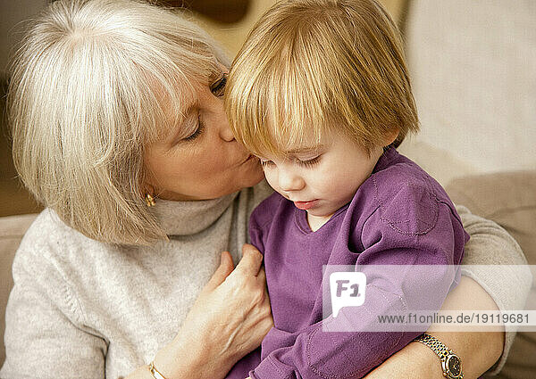 Grandmother kissing grandchild