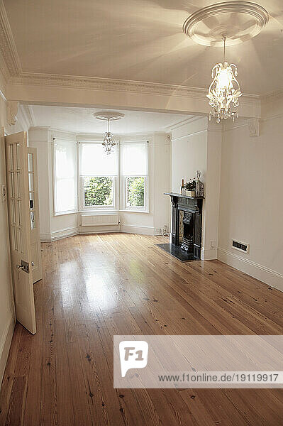 Empty room with fireplace and bay window