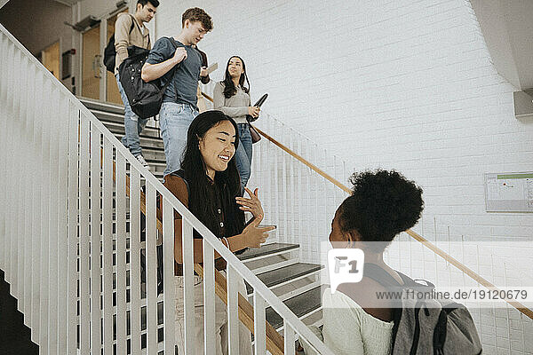 Multiracial students on steps in university