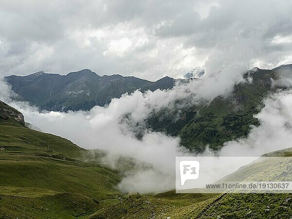 Alpine peaks  morning mist drifting over a mountain ridge  view from the Grossglockner High Alpine Road  Hohe Tauern National Park  Carinthia  Austria  Europe