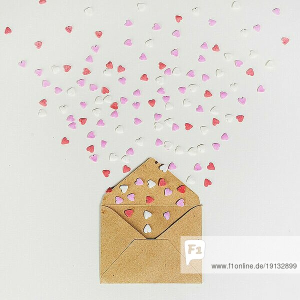 Envelope with small paper hearts white table