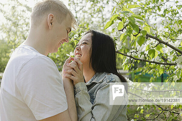 Smiling romantic couple looking at each other in park