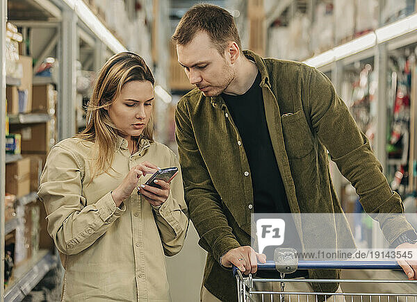 Young couple shopping at supermarket