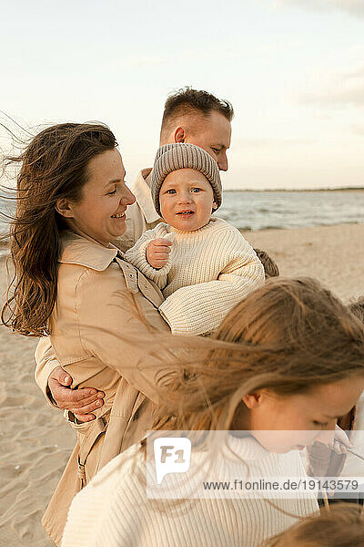 Happy mother enjoying with family at beach