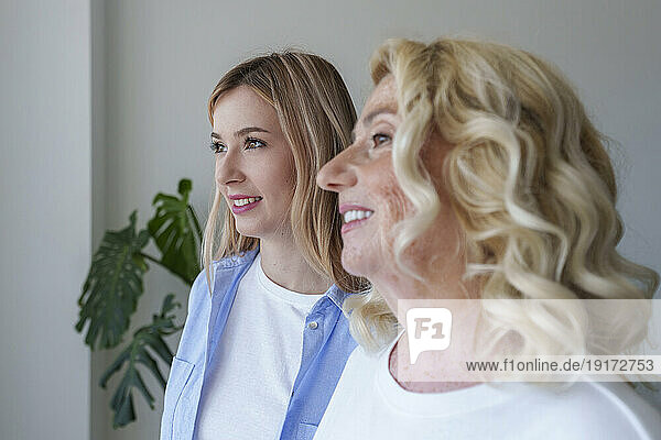 Happy beautiful woman with mother at home