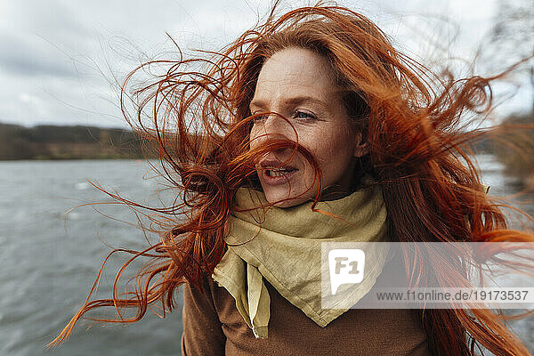 Redhead woman with hair blowing in wind