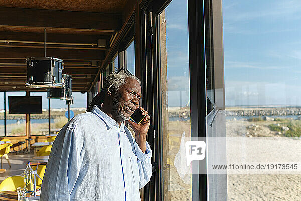 Engineer talking on smart phone by glass window