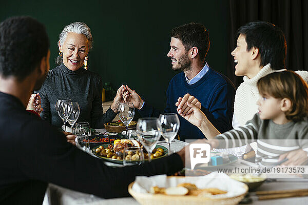 Multiracial family having dinner together at home