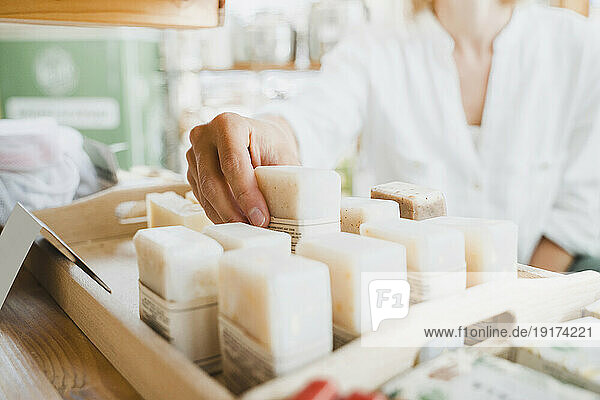 Woman buying scented soap in shop
