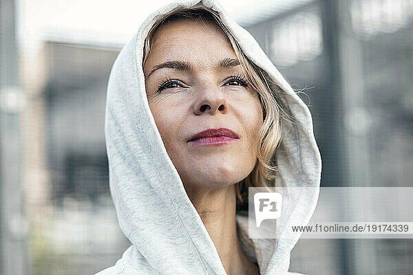 Thoughtful woman wearing hooded shirt