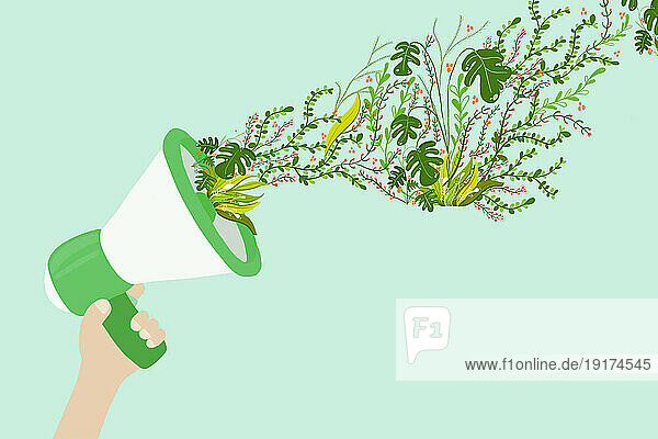 Illustration of hand holding megaphone spewing green plants