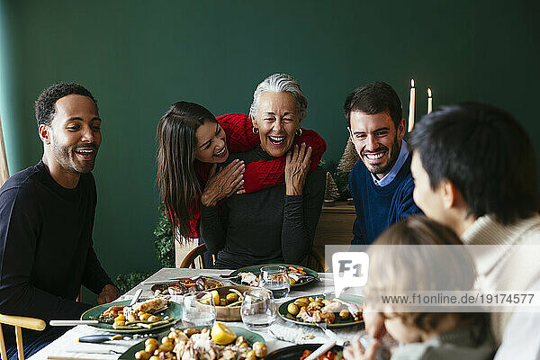 Multiracial family enjoying dinner party on Christmas vacation