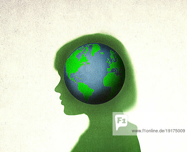 Planet Earth inside silhouette of woman