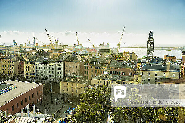 Italy  Liguria  Genoa  Apartment buildings with harbor cranes in background