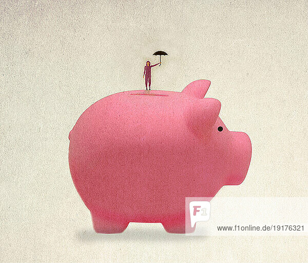 Woman standing on top of oversized piggy bank with umbrella in hand