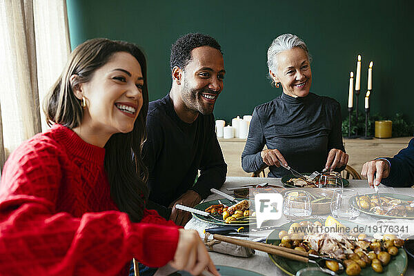 Smiling family having dinner together in dining room