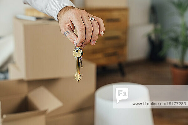 Hands of young man holding house keys