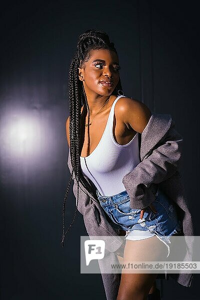 Fashionable urban style with an African girl with braids on a street in ...
