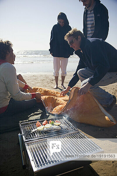 Friends having a barbeque on the beach
