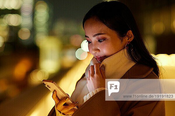 Young Japanese woman using smartphone