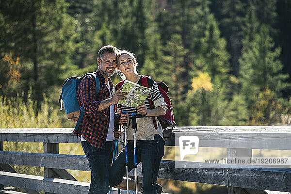 Austria  Alps  happy couple on a hiking trip standing on a bridge