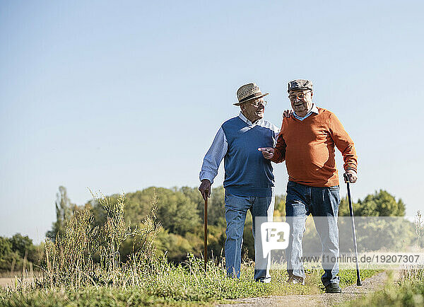 Two old friends taking a stroll through the fields  talking about old times