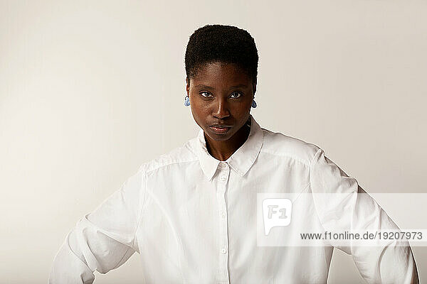 Young woman with short hair against white background