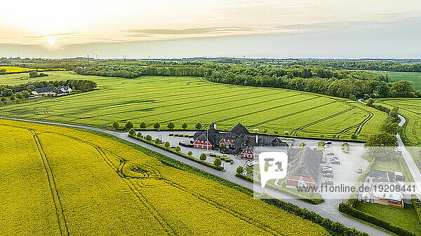 Denmark  Syddanmark  Christiansfeld  Aerial view of village surrounded by summer fields at sunset