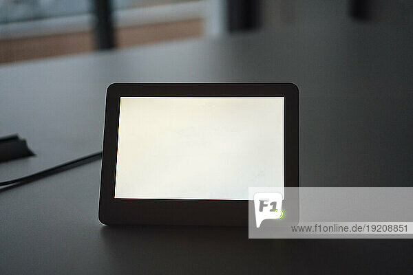 Tablet PC with white blank screen at desk