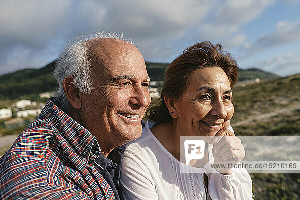 Smiling senior man and woman on sunny day