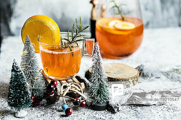 Cups of aperitif with Christmas decoration on table